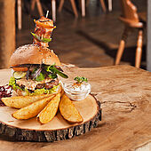 Burger with potato wedges with sour cream dip